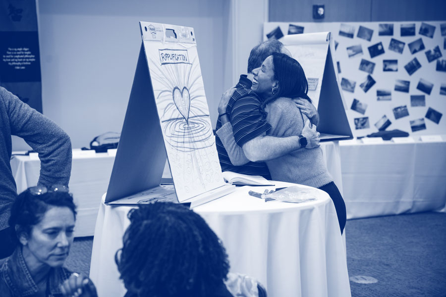 Photo of two people hugging at an inclusive event